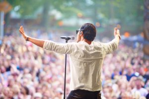 A singer performing on stage at an outdoor music festivalhttp://195.154.178.81/DATA/i_collage/pi/shoots/782675.jpg